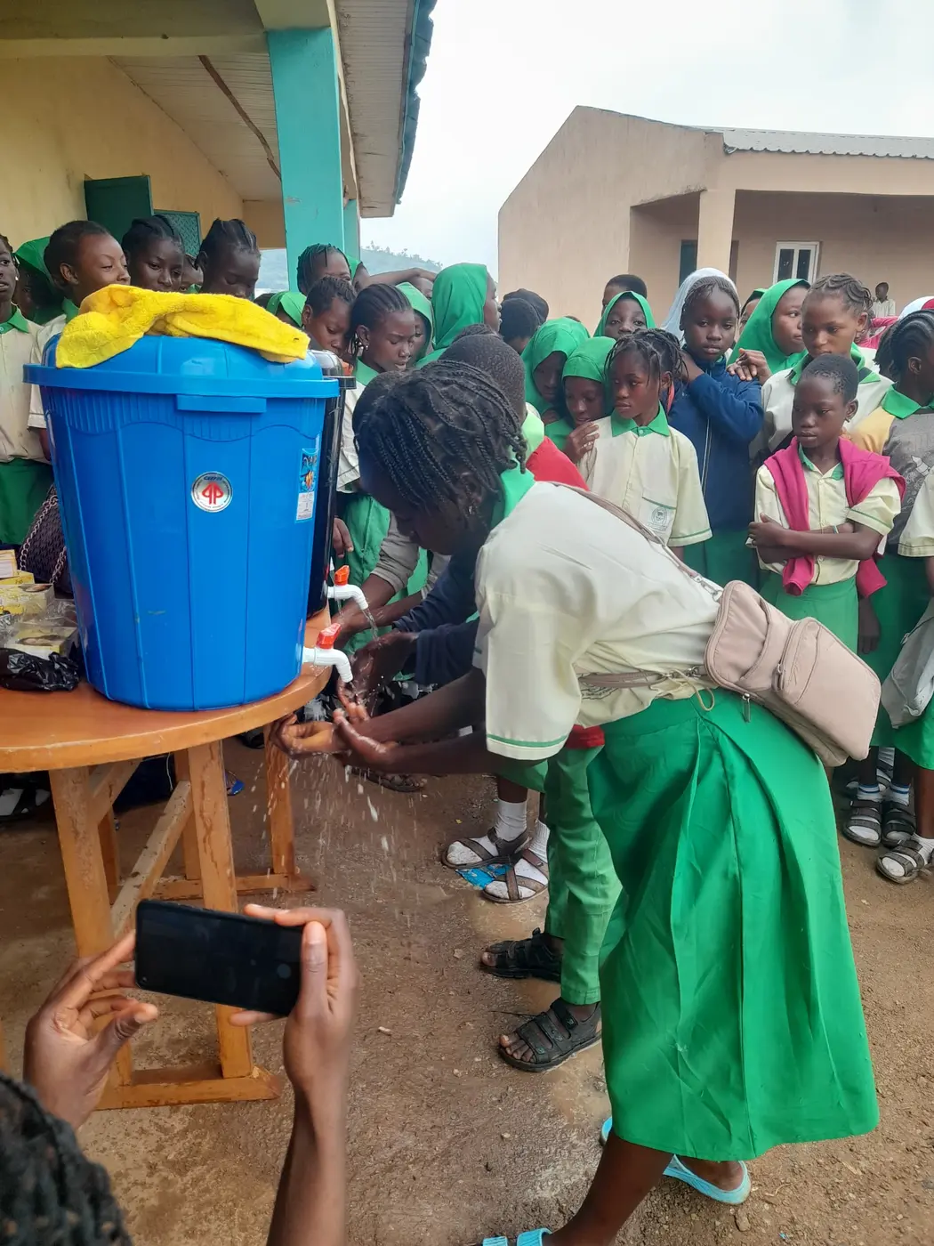 WEMAI team members engaging students during a community school activity